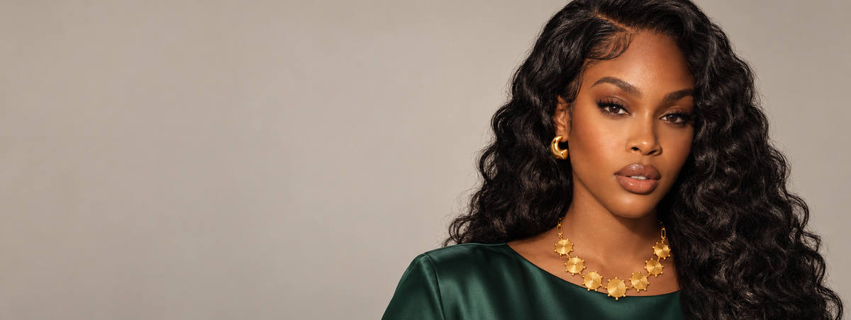 Ava wearing the Goddess Spiral Necklace against a light greige background.