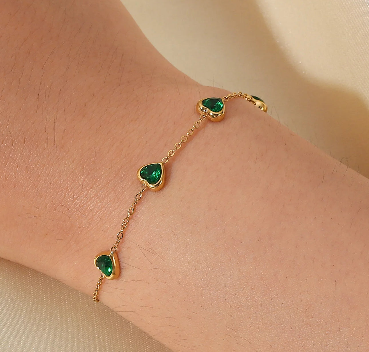 Heartfelt Charm Gold Bracelet with Emerald Accents